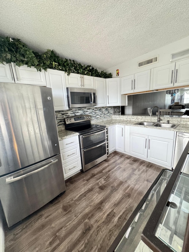 kitchen featuring white cabinets, dark hardwood / wood-style floors, sink, and appliances with stainless steel finishes