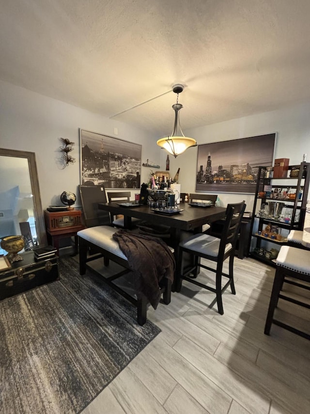 dining area featuring a textured ceiling