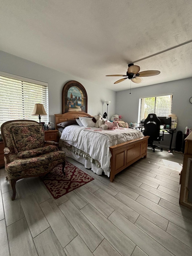 bedroom with a textured ceiling and ceiling fan