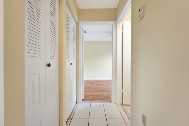 hall with light tile patterned floors