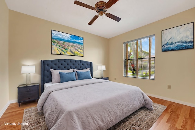 bedroom with ceiling fan and light hardwood / wood-style flooring