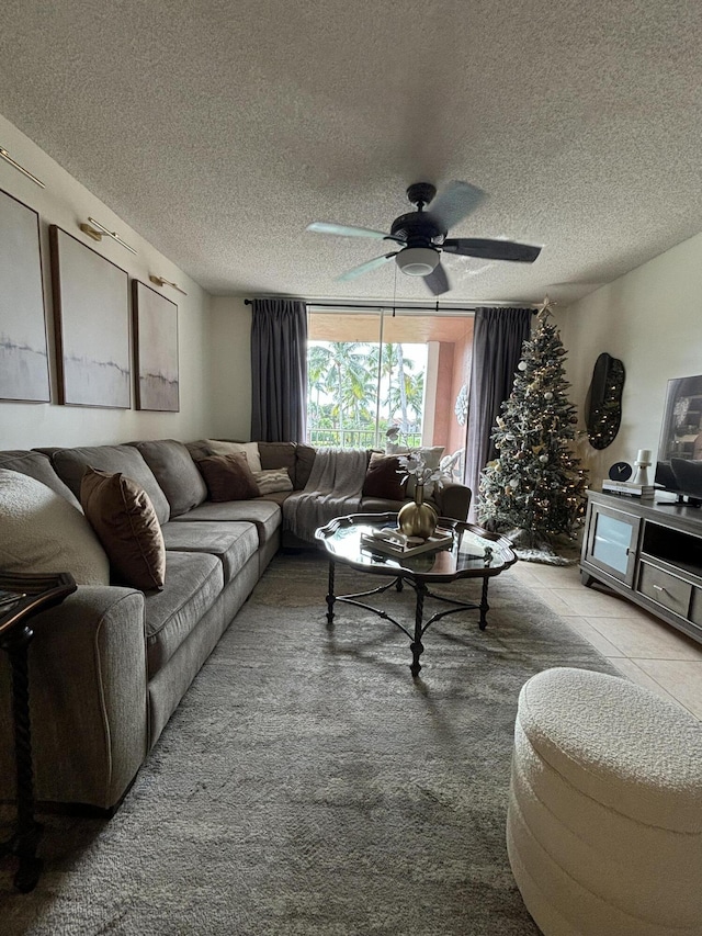 living room with a textured ceiling and ceiling fan