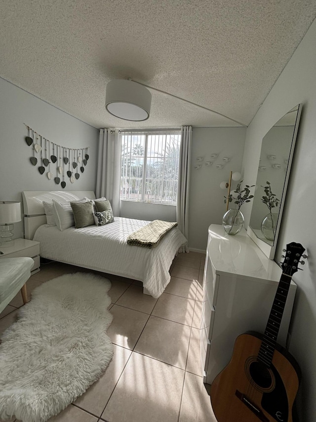 bedroom featuring tile patterned floors and a textured ceiling