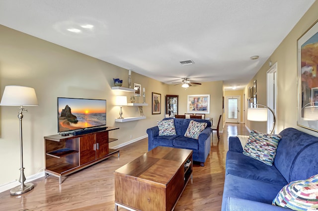 living room with ceiling fan and light hardwood / wood-style floors