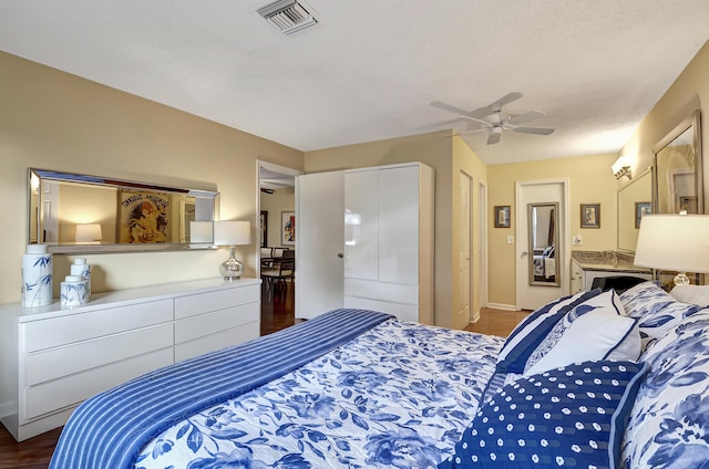 bedroom with dark hardwood / wood-style flooring and ceiling fan