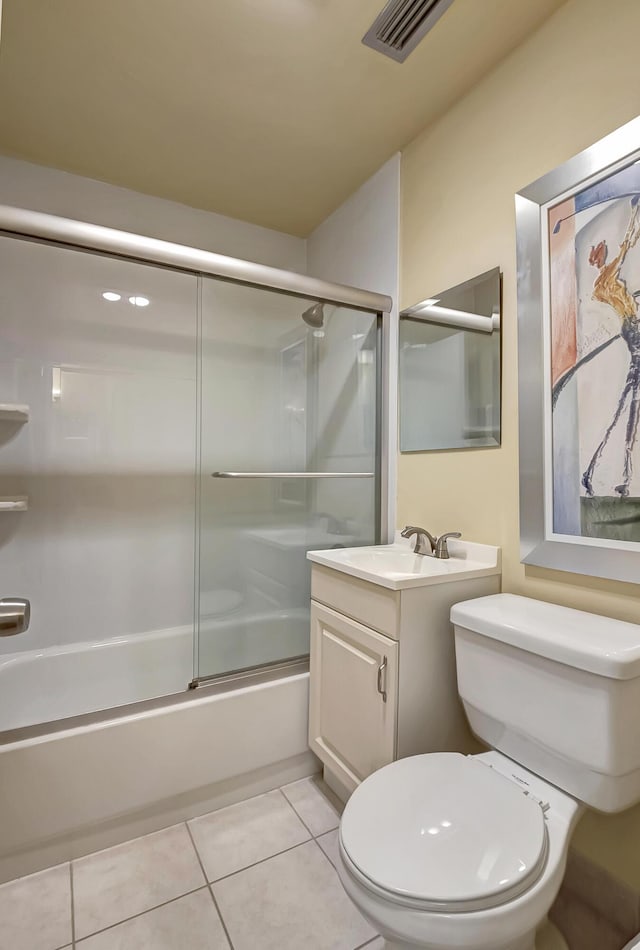 full bathroom with tile patterned floors, vanity, toilet, and shower / bath combination with glass door