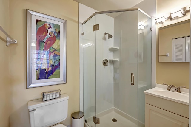 bathroom featuring vanity, toilet, and walk in shower