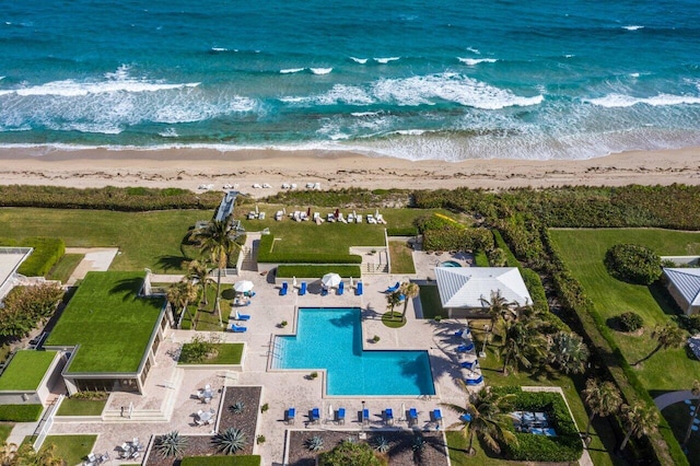 drone / aerial view featuring a beach view and a water view