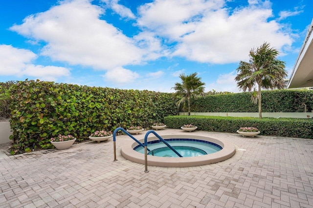 view of pool with an in ground hot tub and a patio