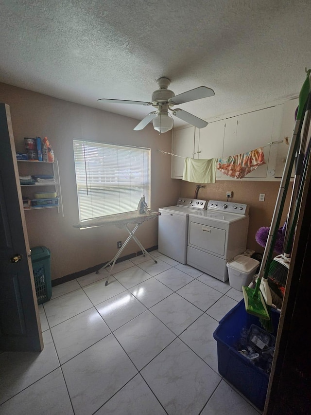 laundry room with washer and dryer, ceiling fan, light tile patterned floors, and a textured ceiling