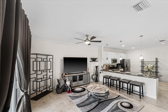 living room featuring ceiling fan, light tile patterned floors, and ornamental molding