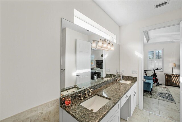 bathroom featuring tile patterned flooring, vanity, and a textured ceiling