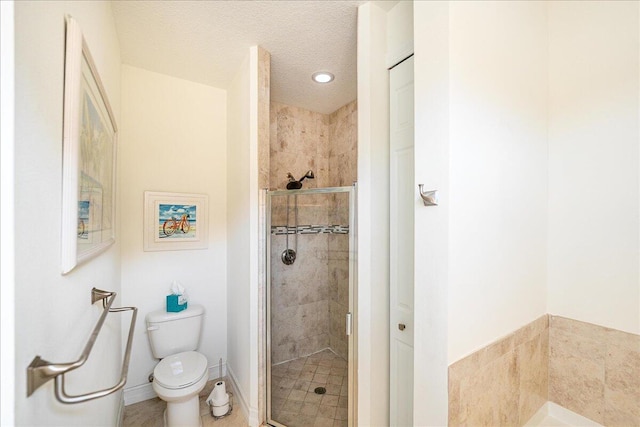 bathroom featuring toilet, a textured ceiling, and walk in shower