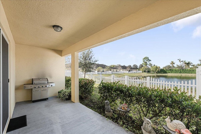 view of patio / terrace featuring area for grilling and a water view