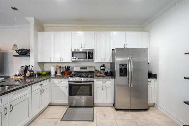 kitchen featuring stainless steel appliances, white cabinetry, hanging light fixtures, and light tile patterned flooring