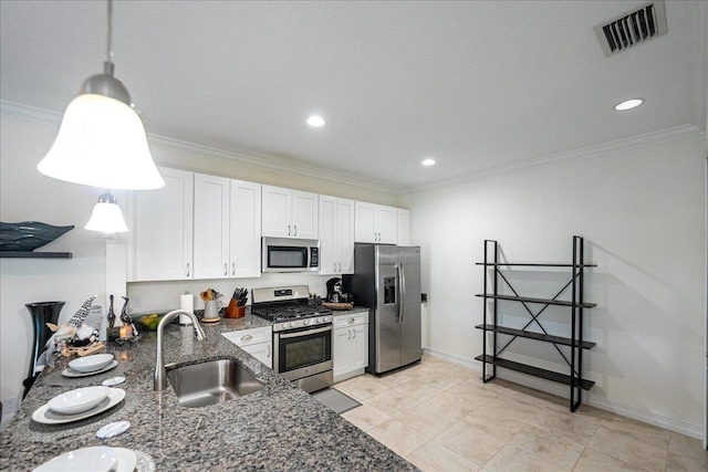 kitchen with white cabinets, appliances with stainless steel finishes, decorative light fixtures, and sink