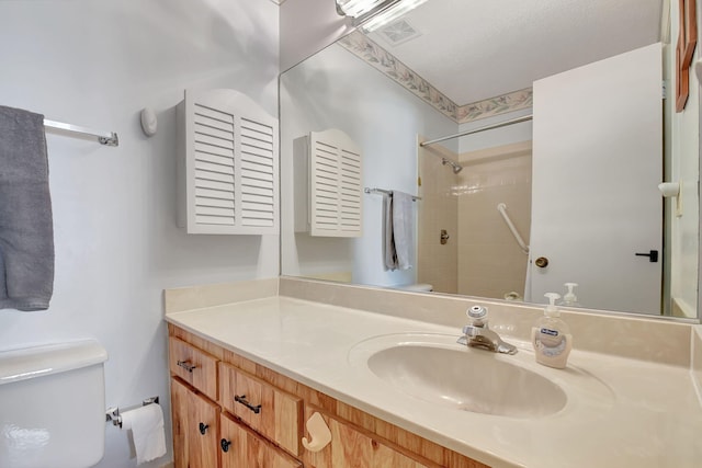 bathroom with walk in shower, vanity, and toilet