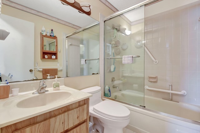 full bathroom with vanity, toilet, ornamental molding, and bath / shower combo with glass door