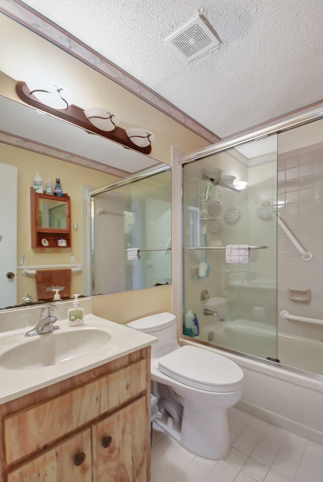 full bathroom featuring tile patterned floors, vanity, a textured ceiling, shower / bath combination with glass door, and toilet