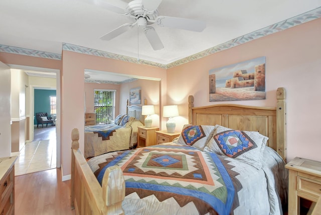 bedroom featuring light wood-type flooring and ceiling fan