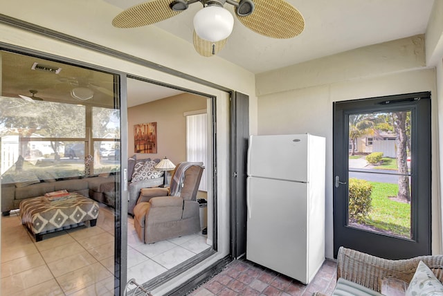 kitchen with tile patterned floors, ceiling fan, and white refrigerator