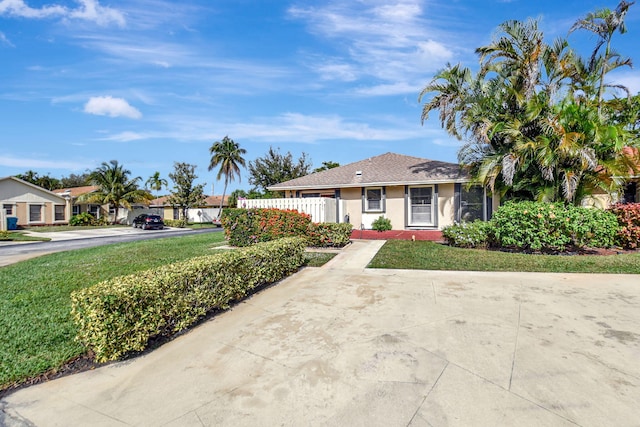 ranch-style home with a front yard