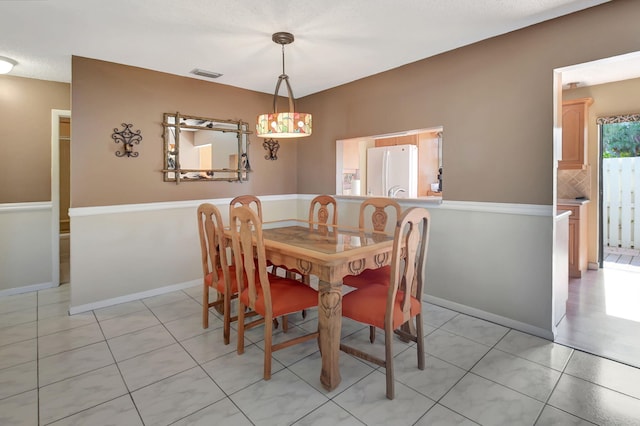 dining space with light tile patterned flooring