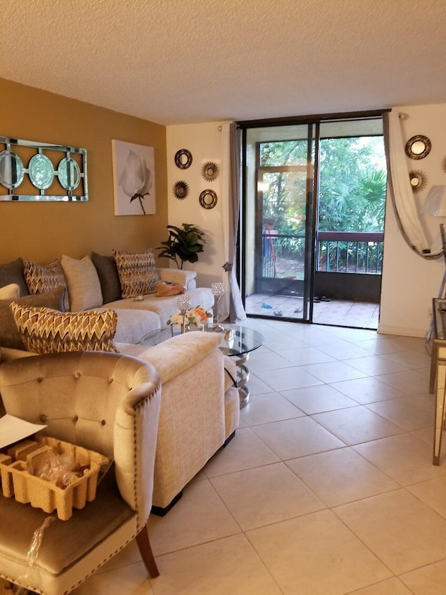 living room featuring floor to ceiling windows, light tile patterned floors, and a textured ceiling