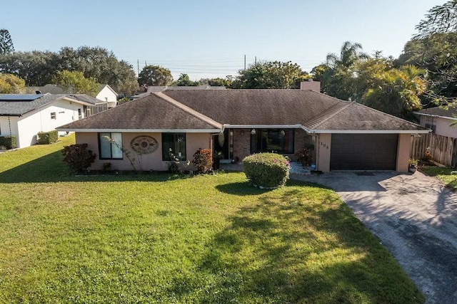 ranch-style home with a front yard and a garage