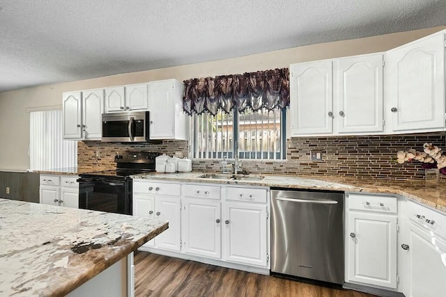 kitchen featuring white cabinets, appliances with stainless steel finishes, and a textured ceiling