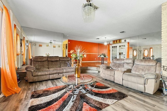 living room with hardwood / wood-style floors and a textured ceiling