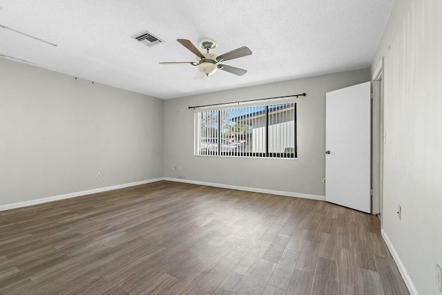 spare room with wood-type flooring, a textured ceiling, and ceiling fan