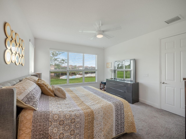 bedroom with ceiling fan, carpet floors, and multiple windows