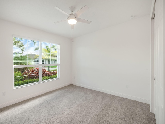 empty room featuring light carpet and ceiling fan