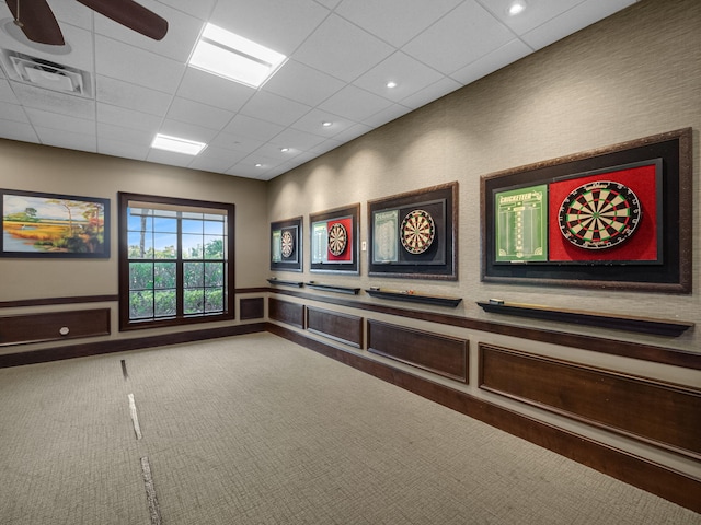 interior space with ceiling fan, carpet, and a paneled ceiling