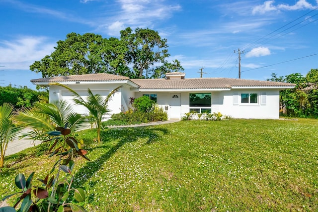 view of front of house with a front yard and a garage