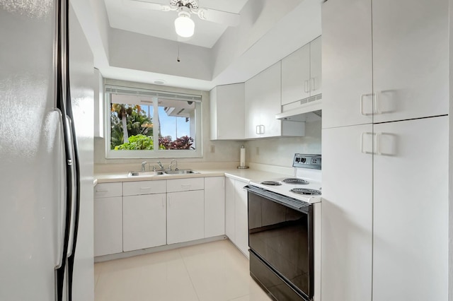 kitchen with white appliances, white cabinetry, ceiling fan, and sink