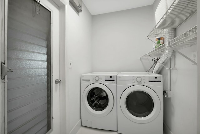 clothes washing area with washer and clothes dryer