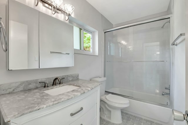 full bathroom with vanity, toilet, and enclosed tub / shower combo