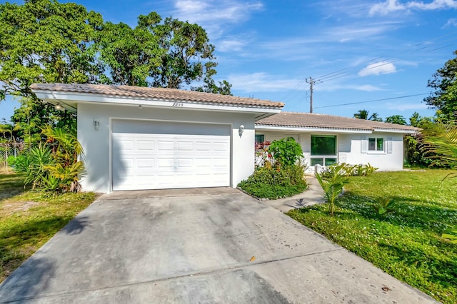 ranch-style home with a garage and a front yard