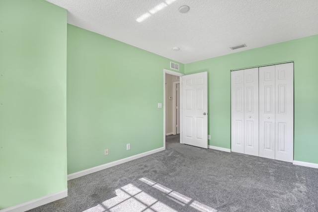 unfurnished bedroom with a closet, carpet, and a textured ceiling