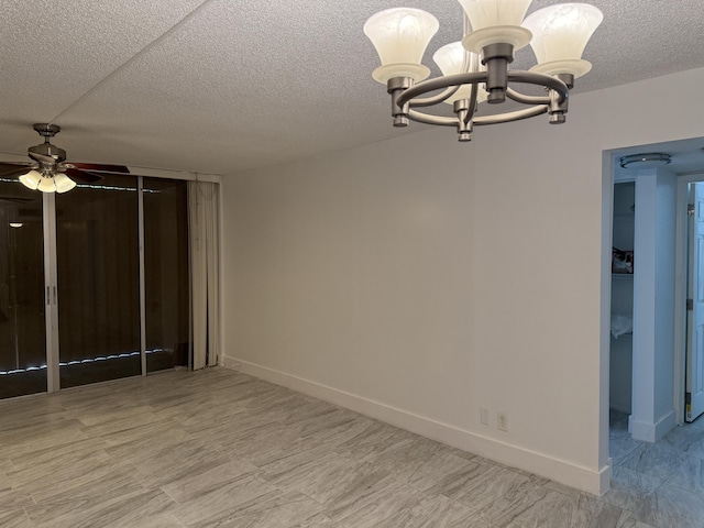 interior space with ceiling fan with notable chandelier