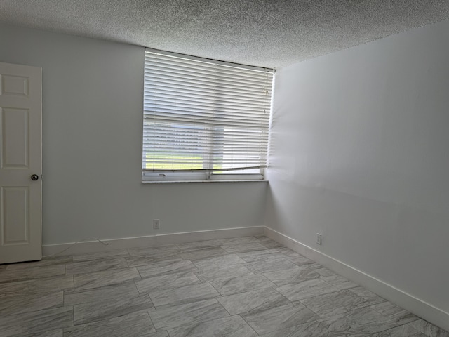 spare room with a textured ceiling