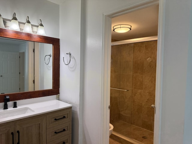 bathroom featuring walk in shower, vanity, and toilet