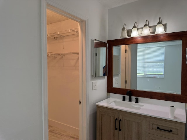 bathroom with a textured ceiling and vanity