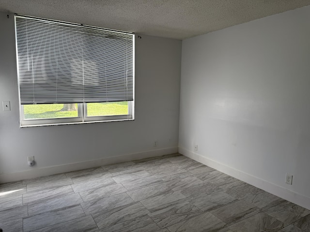 spare room featuring a textured ceiling