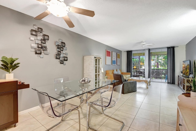 dining space with expansive windows, ceiling fan, light tile patterned floors, and a textured ceiling