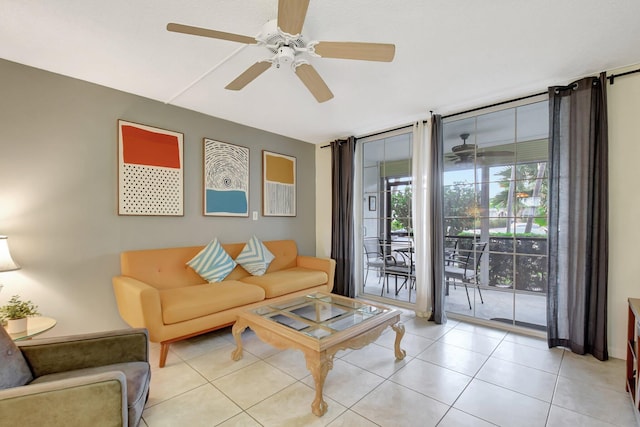 living room with ceiling fan, expansive windows, and light tile patterned flooring