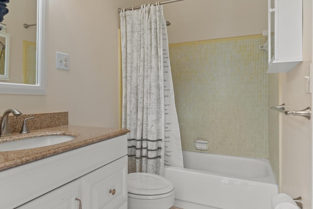 full bathroom featuring vanity, toilet, and shower / tub combo with curtain