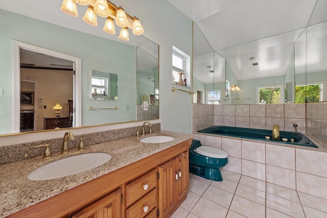 bathroom with tile patterned floors, tiled bath, vanity, and lofted ceiling